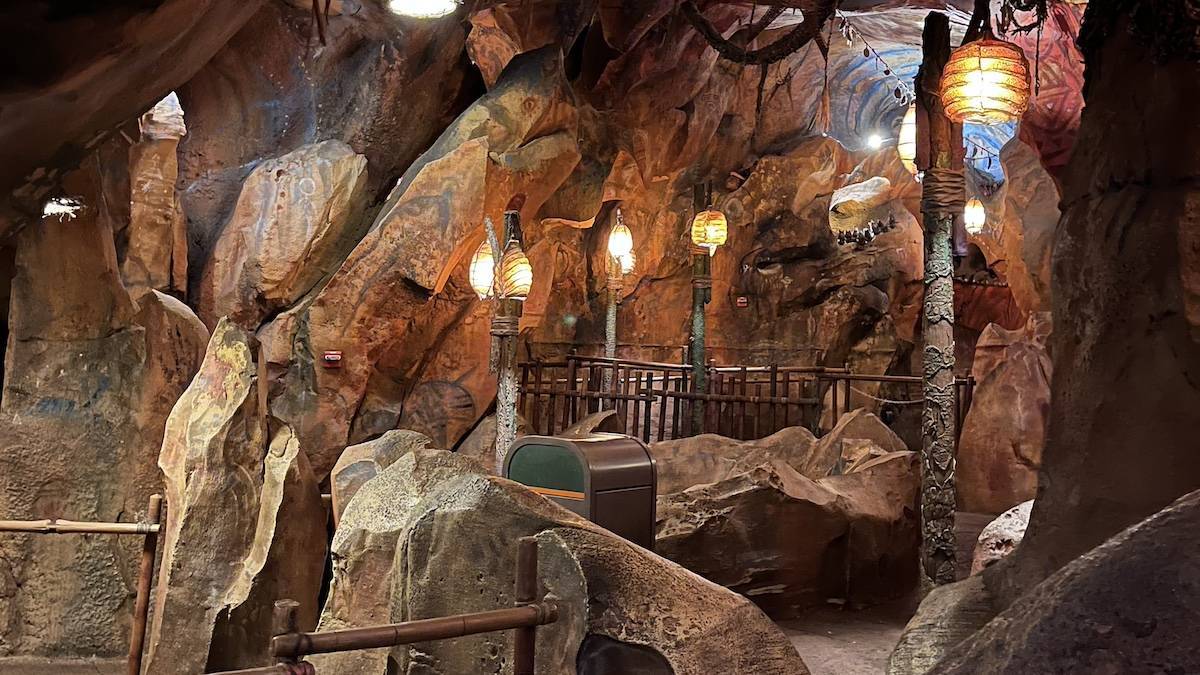 Queue line for Avatar Flight of Passage in an interior stone room with hanging lights